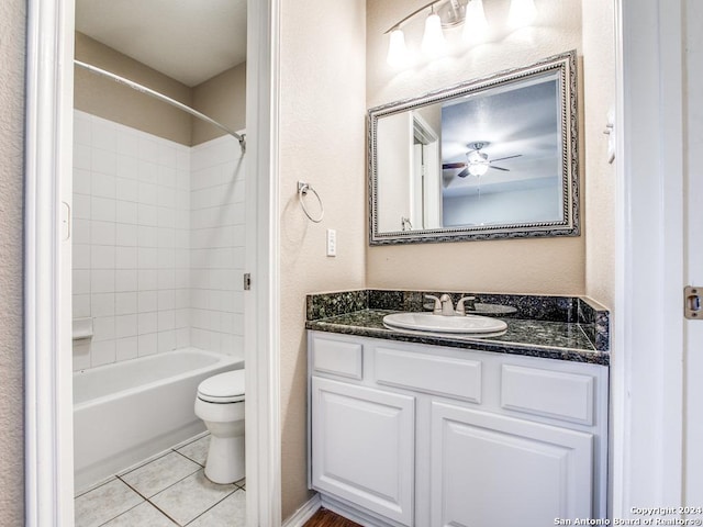 full bathroom with tile patterned floors, vanity, tiled shower / bath combo, ceiling fan, and toilet