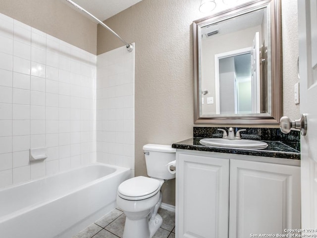 full bathroom featuring washtub / shower combination, tile patterned floors, vanity, and toilet