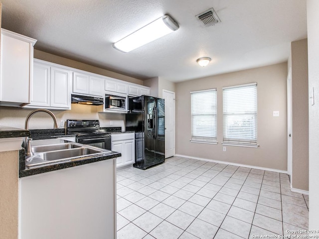 kitchen with white cabinets, light tile patterned floors, sink, and black appliances