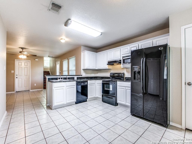 kitchen with ceiling fan, kitchen peninsula, extractor fan, white cabinets, and black appliances