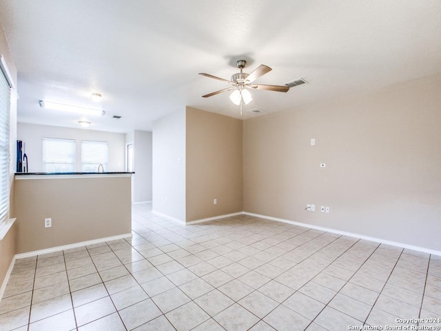 unfurnished room featuring ceiling fan and light tile patterned flooring