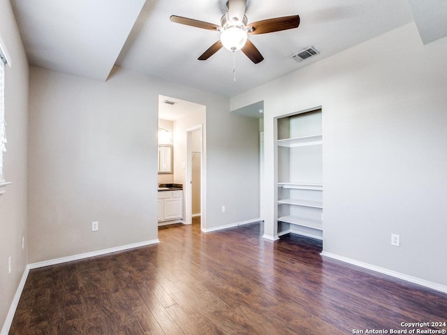 unfurnished bedroom featuring dark hardwood / wood-style floors, ceiling fan, and ensuite bathroom