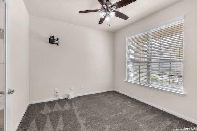 carpeted spare room featuring ceiling fan