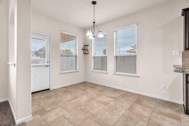 unfurnished dining area with an inviting chandelier