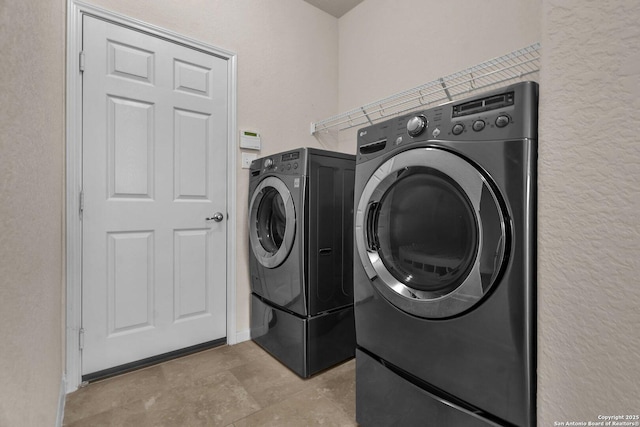 clothes washing area featuring washer and clothes dryer