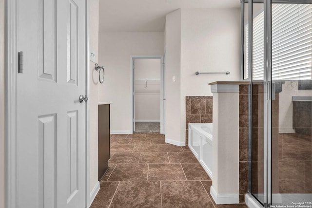 hallway with dark tile patterned floors