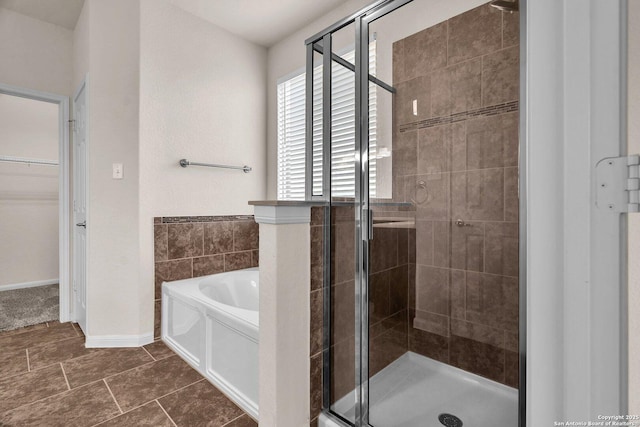 bathroom featuring tile patterned floors and independent shower and bath