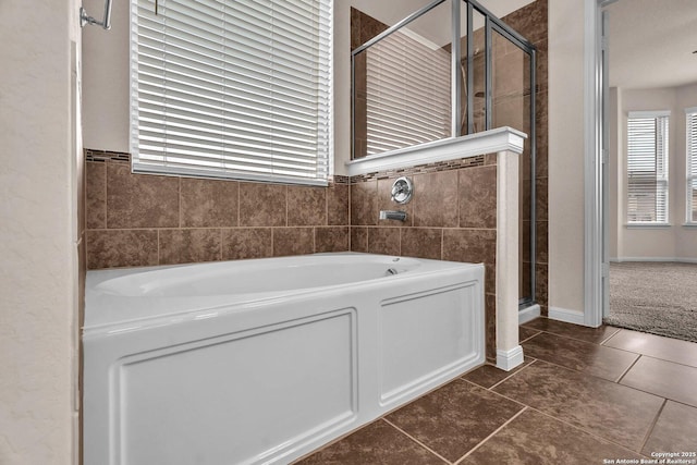 bathroom with tile patterned floors and independent shower and bath