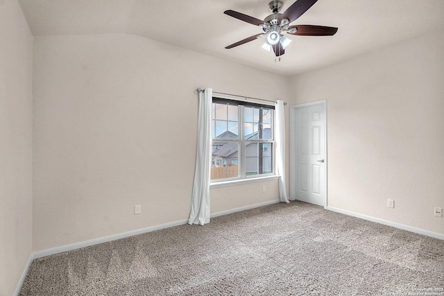 carpeted empty room featuring ceiling fan and lofted ceiling