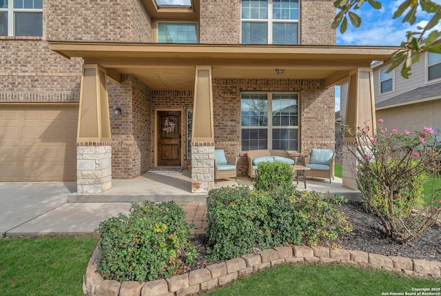 entrance to property featuring a porch and a garage