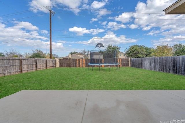 view of yard featuring a patio area and a trampoline