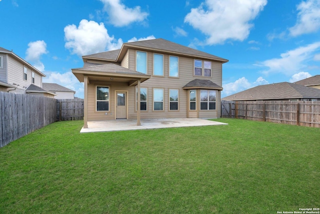 rear view of house with a yard and a patio area