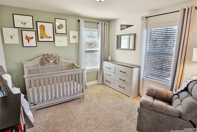 bedroom featuring a crib and light carpet