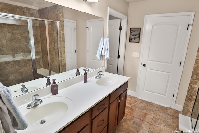 bathroom with vanity and a shower with shower door