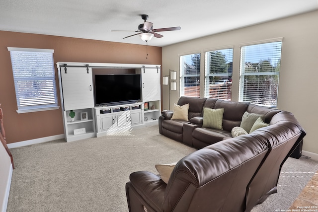 carpeted living room with ceiling fan