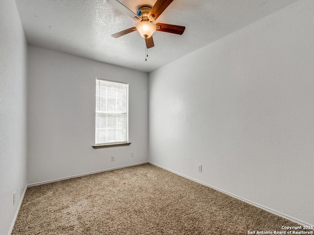 empty room featuring ceiling fan, carpet floors, and a textured ceiling