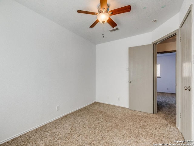 empty room with light carpet and ceiling fan