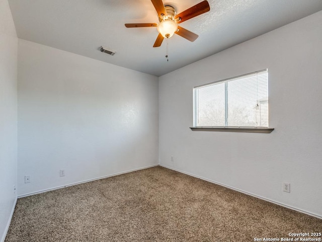 empty room with carpet flooring and ceiling fan