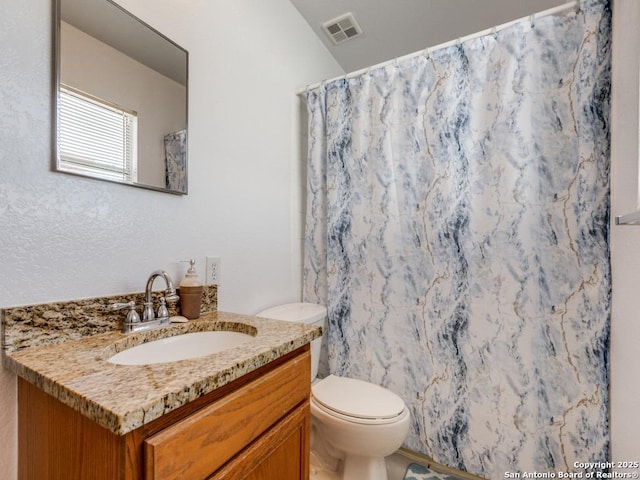 bathroom featuring vanity, a shower with shower curtain, and toilet