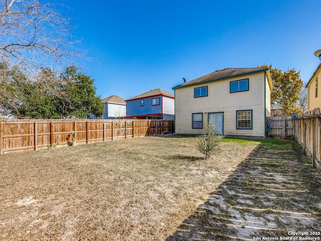 rear view of house featuring a yard