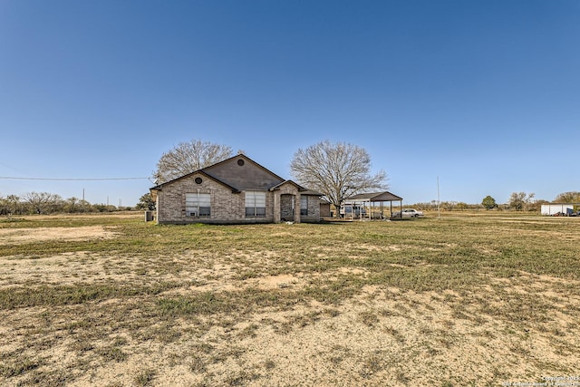 exterior space featuring a rural view and a front yard