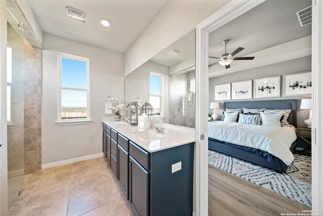 bedroom with light tile patterned flooring, ceiling fan, and sink