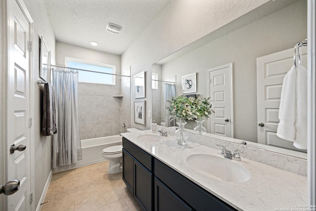 full bathroom with shower / bath combination with curtain, vanity, a textured ceiling, tile patterned flooring, and toilet