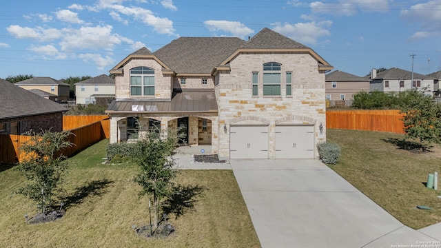 french provincial home featuring a front yard and a garage