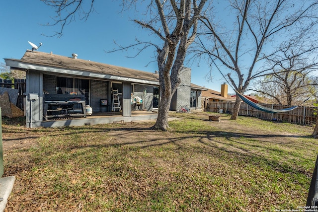 rear view of property with a lawn