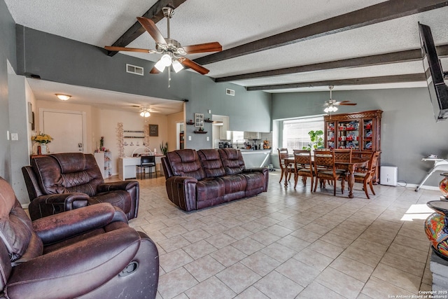 tiled living room with lofted ceiling with beams and a textured ceiling