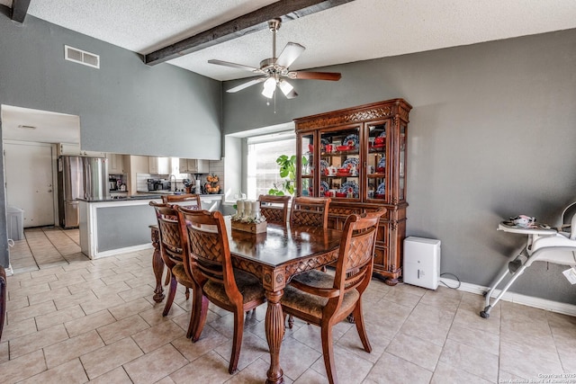 tiled dining area featuring beamed ceiling, ceiling fan, sink, and a textured ceiling