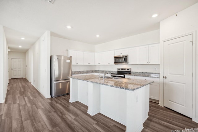 kitchen with a center island with sink, white cabinetry, and appliances with stainless steel finishes