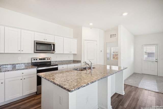 kitchen featuring an island with sink, stainless steel appliances, white cabinetry, and sink