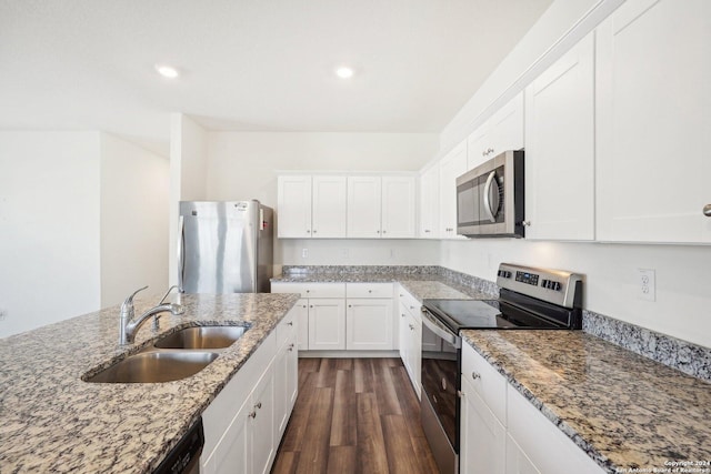 kitchen featuring stone countertops, white cabinetry, sink, and appliances with stainless steel finishes