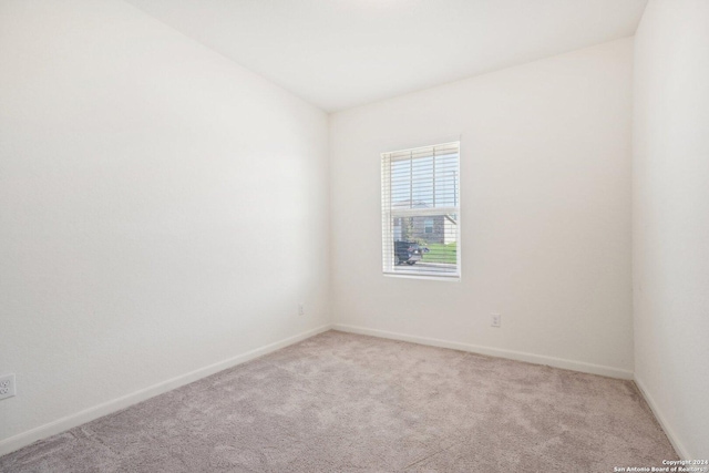 empty room with light colored carpet