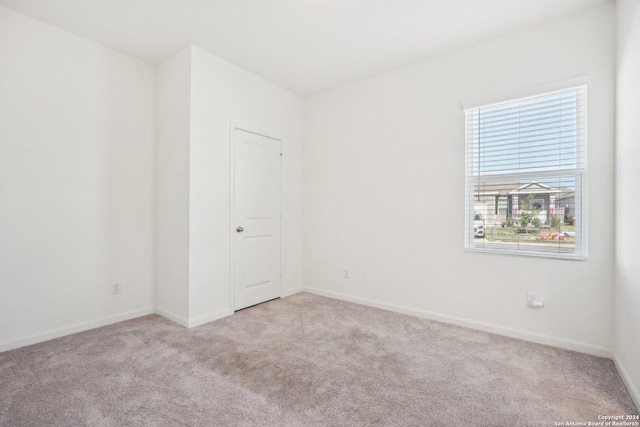 empty room with light colored carpet