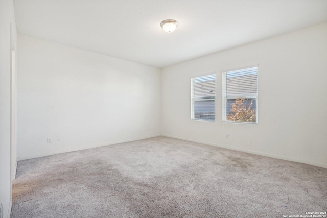 spare room with light colored carpet