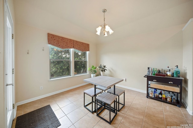 dining room with light tile patterned flooring and a chandelier