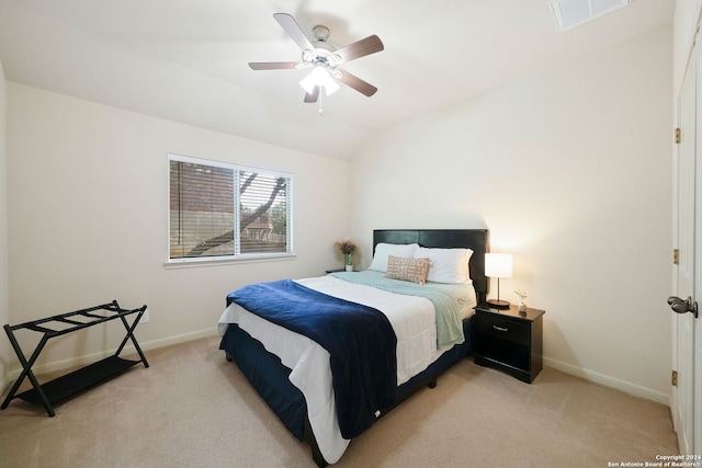 bedroom with light colored carpet, ceiling fan, and lofted ceiling