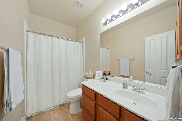 bathroom with tile patterned floors, vanity, and toilet