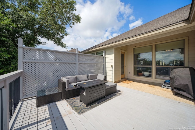 wooden deck with a grill and an outdoor hangout area