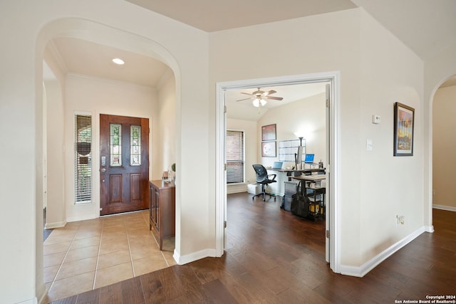 foyer entrance featuring light wood-type flooring, ceiling fan, and lofted ceiling