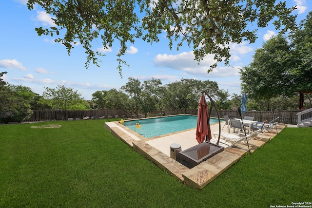 view of pool with a yard and a patio area