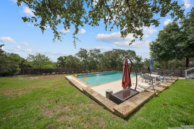 view of pool featuring a patio and a lawn