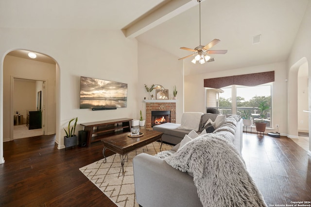 living room with high vaulted ceiling, ceiling fan, a fireplace, beamed ceiling, and dark hardwood / wood-style flooring