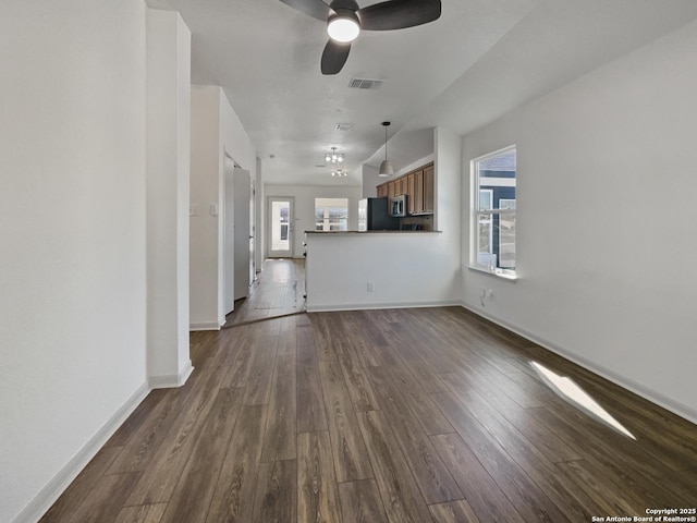 unfurnished living room with ceiling fan and dark hardwood / wood-style floors