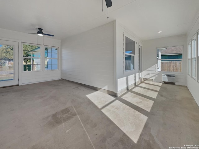 view of patio / terrace featuring a wall mounted air conditioner and ceiling fan