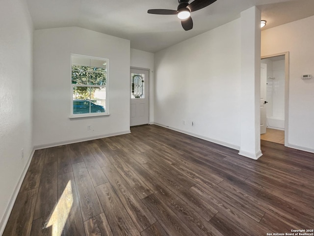 interior space with dark hardwood / wood-style floors, vaulted ceiling, and ceiling fan