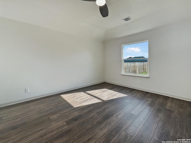 empty room featuring ceiling fan and dark hardwood / wood-style flooring