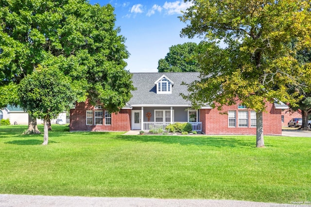 cape cod-style house with covered porch and a front yard